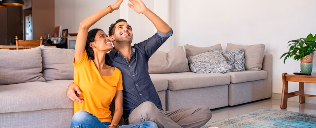 Pareja sentada en el salón de su casa